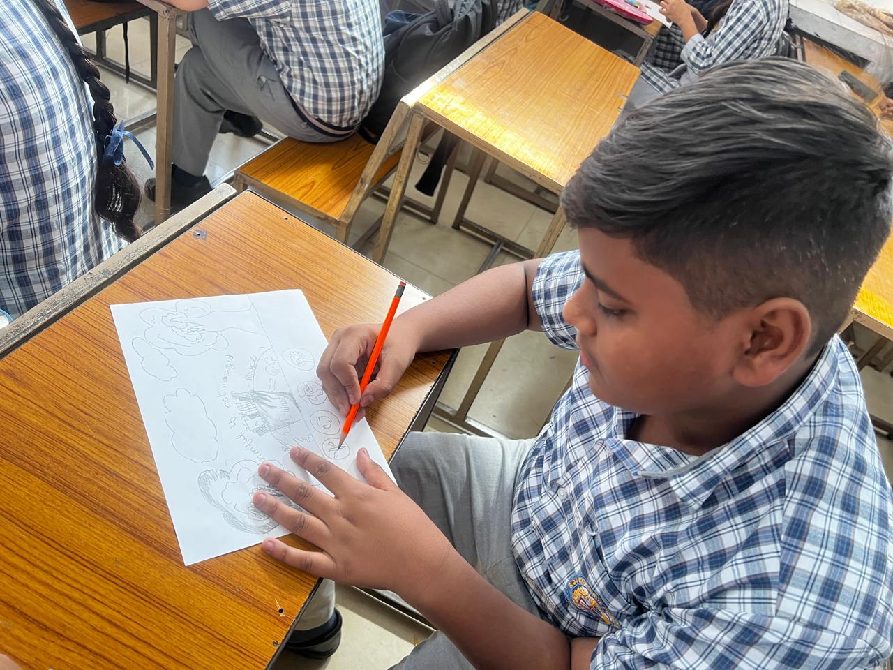 Student writing an environmental message