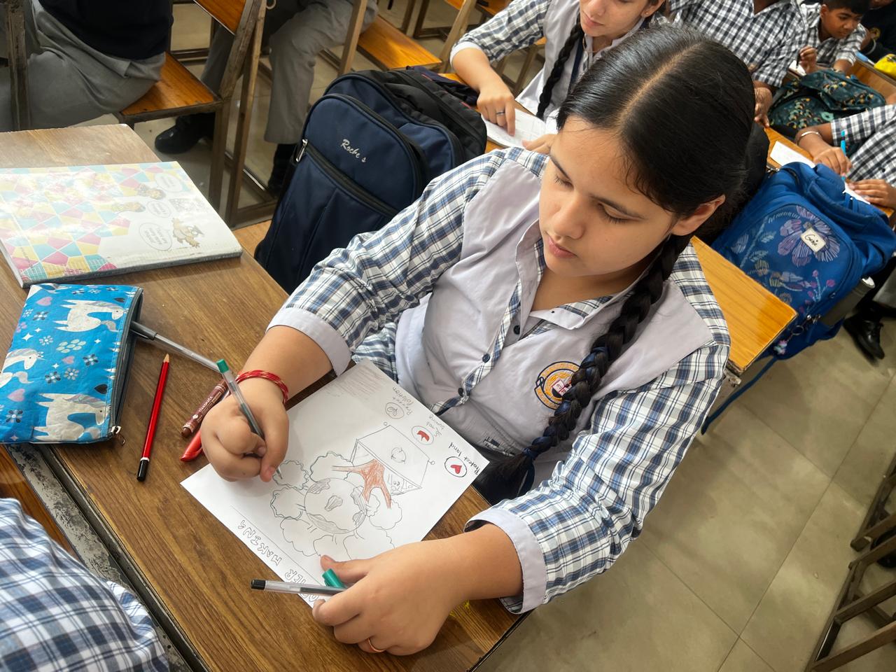 Student writing on an awareness poster
